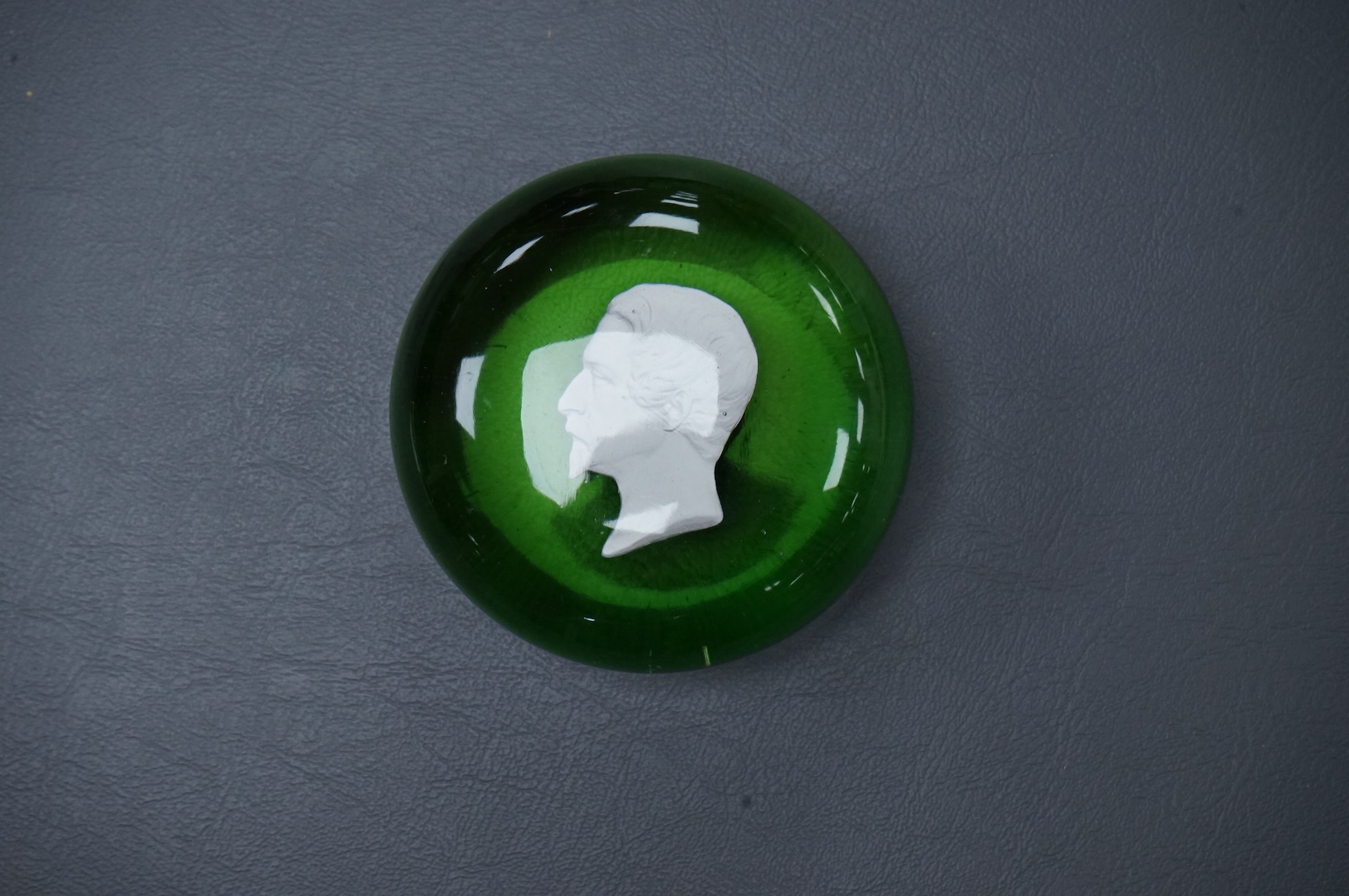 A Clichy Napoleon III sulphide paperweight, green pedestal foot. base 6cm diameter.